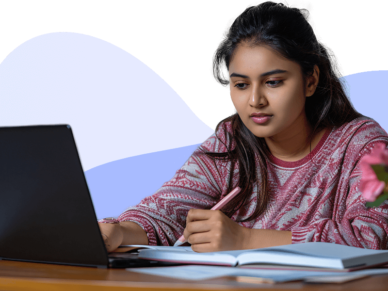 A Women sitting next to laptop learning theology through Online Mode